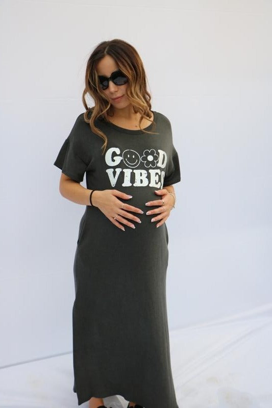 Women's solid dark grey maxi dress with side pockets and "Good Vibes" print